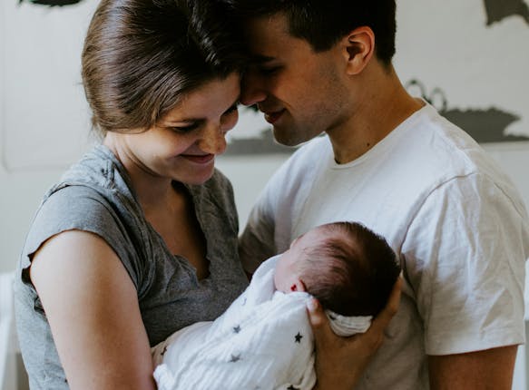 new parents holding a baby thinking about advice for new parents