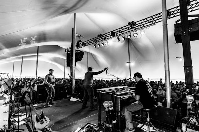 Men worship God and sing songs in the tent at Man Camp through Crossroads Church