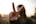 a woman holding up a peace sign