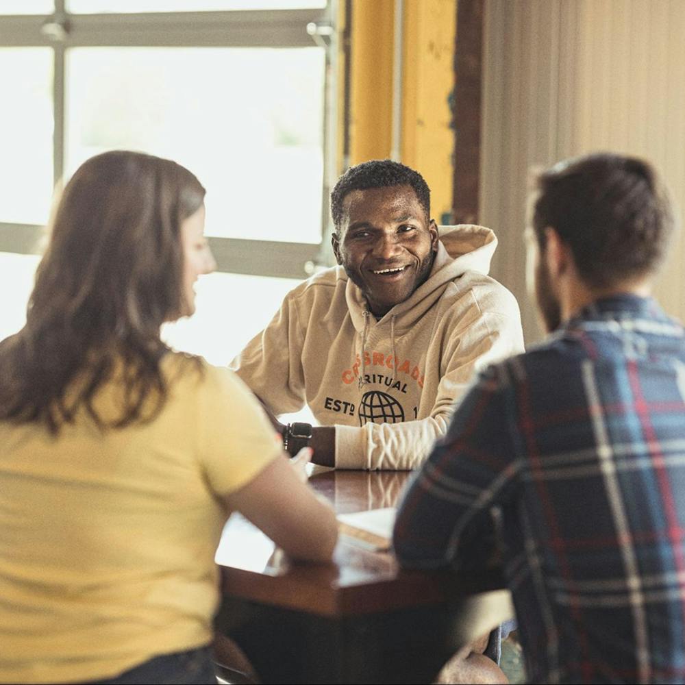 Halftone image of three people meeting in a group
