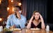 Couple at dinner experiencing marriage problems, wondering about Valentine’s Day gift ideas when they are not feeling it.