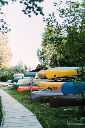 Stacked Canoes to represent the Summer Camp setting where God unexpectedly showed the Author he cared about her grief.