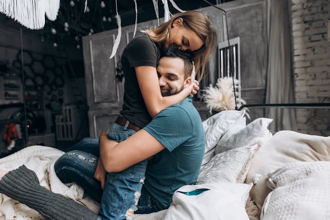 A wife playfully hugging her husband representing the article topic of a wife refocusing on the importance their relationship