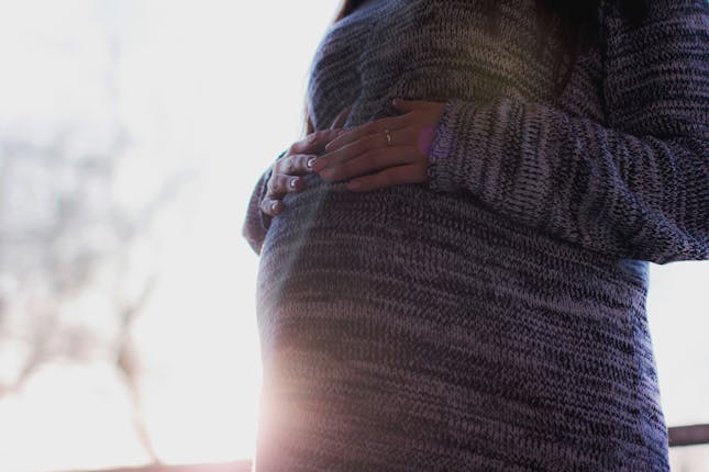 A woman who is pregnant. Why did God make childbirth painful?