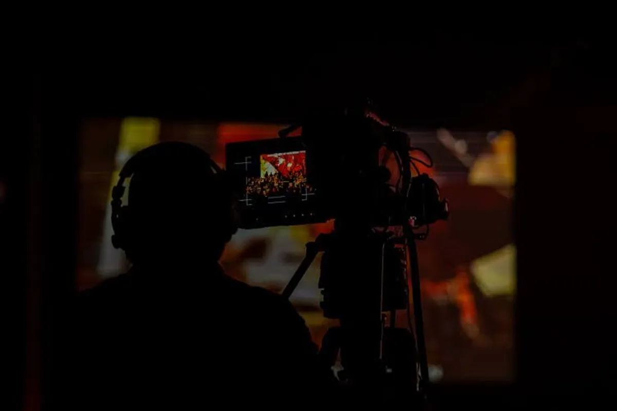 image of student operating a camera at worship u